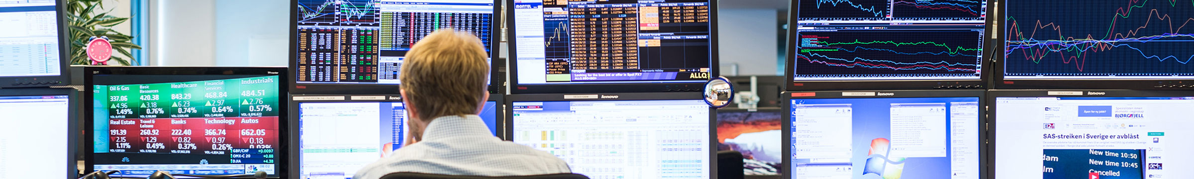 man working in front of computers on trading floor